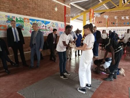 Deux élèves du lycée français Charles Des Gaulles à Bangui font la démonstration d'assistance à une personne en danger. La scène est observée par l'ambassadeur