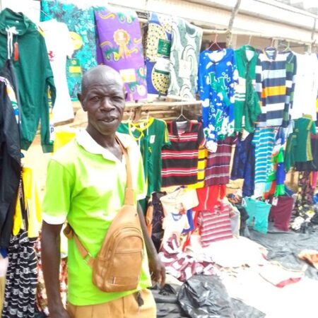 Monsieur Jean Kepesse devant son étalage de vêtements dans le marché hebdomadaire de Baboua, dans la Nana-Mambéré. CopyrightCNC