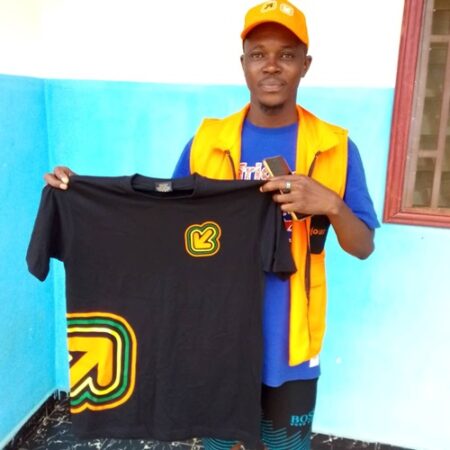 Agent de Orange Centrafrique présentant un T-shirt promotionnel