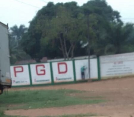 Mur d’enceinte du siège du Parti PGD à Bangui avec des inscriptions.